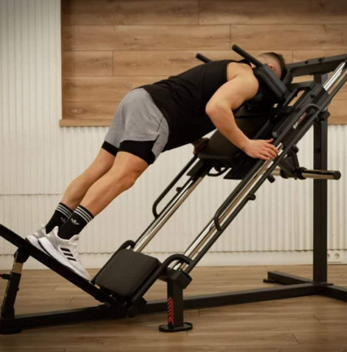 BH Light Commercial Hack Squat/45 Degree Leg Press with male performing forward squat