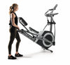 Nordic Track Commercial Elliptical Cross Trainer with female model moving the cross trainer on its transport wheels