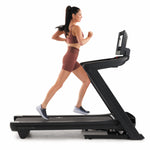 Nordic Track 1750 Treadmill. Side view of a female running on the treadmill.