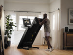 Nordic Track 1750 Treadmill. Image of a male demonstrating how the treadmill folds.