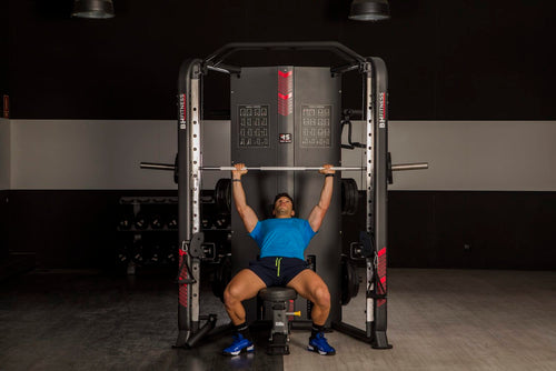 An image of a man performing a bench press on the BH Rack Smith. Fitness Options. Nottingham's leading fitness & gym equipment supplier.