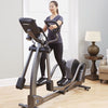 Image showing a female working out on a Life Fitness E5 cross trainer in a home setting.  Fitness Options. Nottingham's leading fitness & gym equipment supplier.