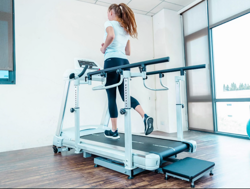 Dyaco Medical Rehabilitation Treadmill 7.0T rear view with female patient walking on it.