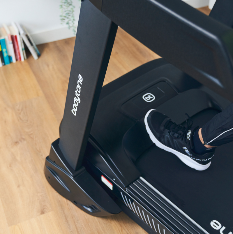 Close up of mans feet at the front of the Bodytone Active Run 600 Smart treadmill