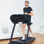 Man using a Bodytone Active Run LED treadmill viewed from the front in a living room setting.