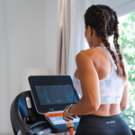 Bodytone DT22W TFT Treadmill in home setting with woman running looking at the console