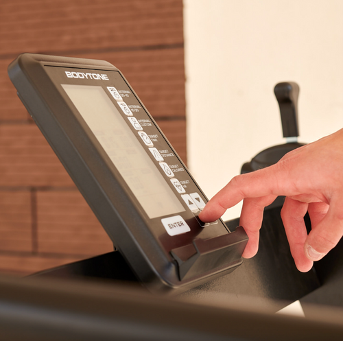 Hand interacting with a treadmill control panel Bodytone ZROT4 Light Commercial Curved Treadmill 