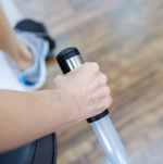 Dyaco Medical Physical Therapy Recumbent Bike 4.0R with close up of hand gripping pulse sensors on seat handle.