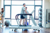 Dyaco Medical Physical Therapy Treadmill 4.0T in gym room with male patient walking on it with therapist standing at the side of the treadmill.