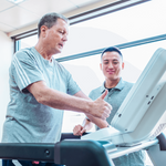 Dyaco Medical Physical Therapy Treadmill 4.0T in gym room viewing the upper torso of the patient with his thumb up and the therapist smiling.