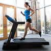 Horizon 7.0AT @Zone Treadmill with female runner viewed from the side in room