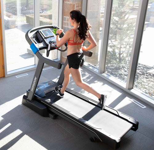 Horizon 7.0AT @Zone Treadmill with female runner viewed from above in room setting