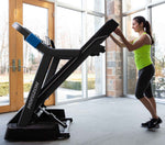 Horizon 7.0AT @Zone Treadmill showing female folding treadmill in room