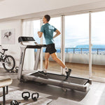 Horizon Paragon X @Zone Treadmill with male runner in room setting with a back drop of large windows