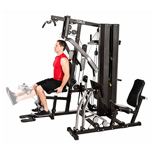 Horizon Torus 5 Gym with male model performing leg extension