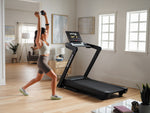 Nordic Track EXP 10i Treadmill in room with female exercising at the side of the treadmill