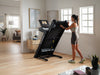 Nordic Track EXP 10i Treadmill being folded by female in room