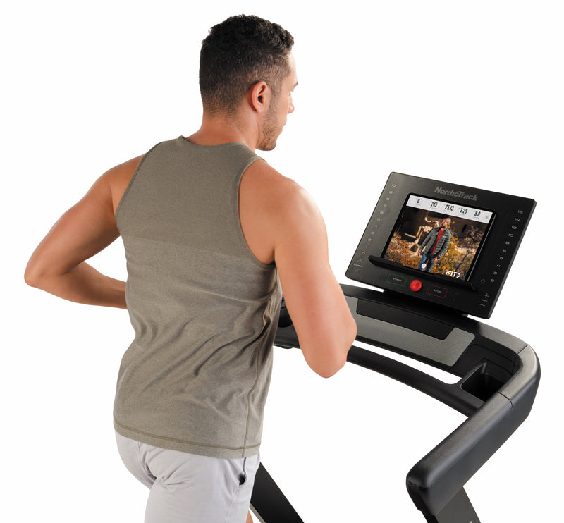Nordic Track EXP 5i Treadmill with male viewing close up of tablet