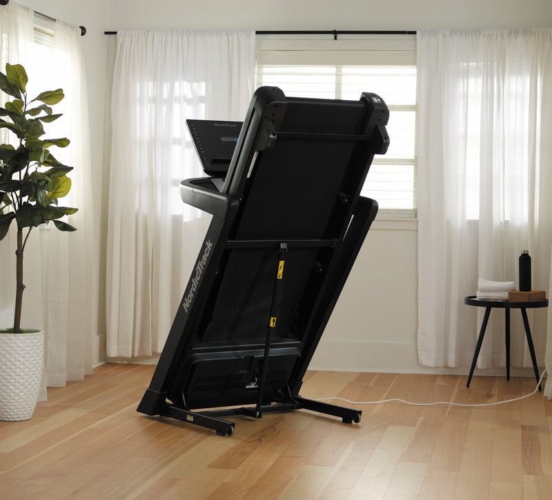 Nordic Track EXP 5i Treadmill folded in room