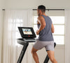 Nordic Track EXP 5i Treadmill with male runner looking at tablet in room