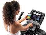 Nordic Track Freestrider Trainer FS10. Image of a female pairing her phone with the Freestrider.