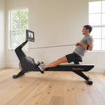 Nordic Track RW700 Rower. Image of a male rowing in a home setting.