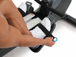 Nordic Track RW900 Rower.  Image of a male demonstrating how to use the foot straps on the footplates.