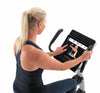 Nordic Track VU29 Upright Bike. An image of a female demonstrating the touch screen console.