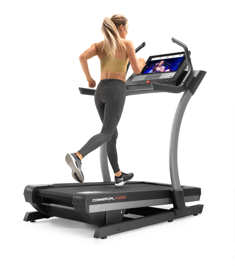 Nordic Track X22i Incline Trainer with female running on decline