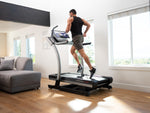 Nordic Track X22i Incline Trainer in room setting with male running on the flat