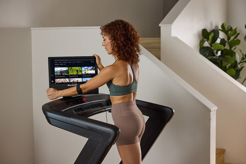  NordicTrack Commercial 1750 showing a close up of console being tilted by female