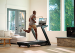 NordicTrack Commercial 2450 Treadmill with male running without incline in room setting