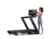 NordicTrack Commercial 2450 Treadmill with woman tilting console against white background