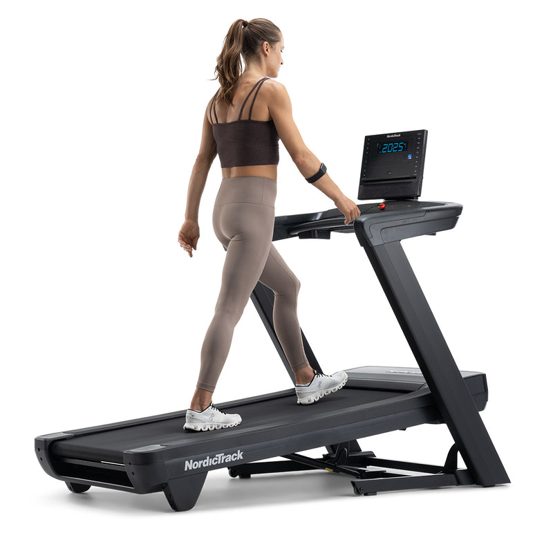 NordicTrack Commercial LE Treadmill with woman walking against white background