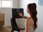 NordicTrack RW300 Rowing machine with woman using its console.