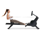 NordicTrack RW300 Rowing machine side view of woman using rower against white background