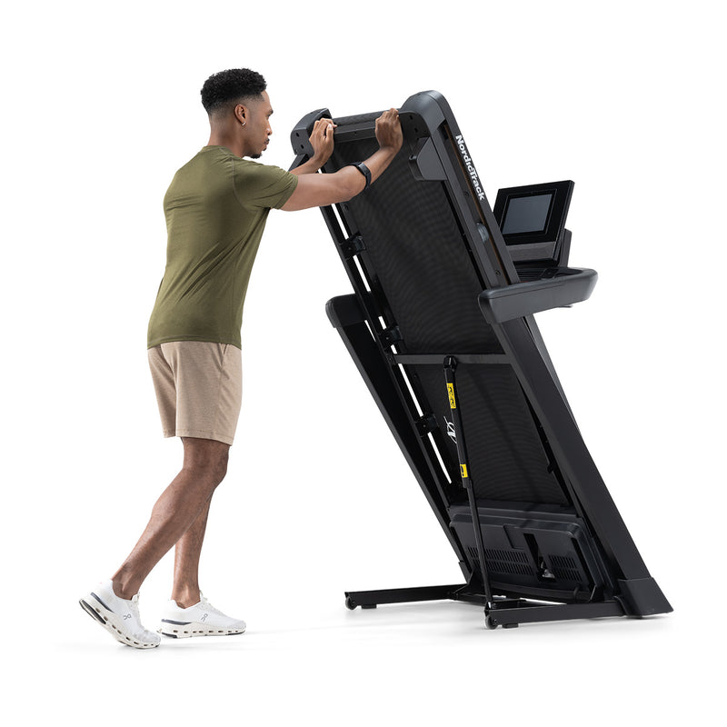 NordicTrack T10 Treadmill with man folding the treadmill