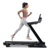 NordicTrack T10 Treadmill side view with woman running on it against white background