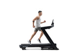 Nordic Track Commercial 1250 Treadmill side view with man running on a flat surface against a white background