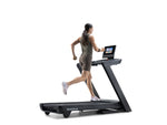 Nordic Track Commercial 1250 Treadmill with woman running on it against a white background.
