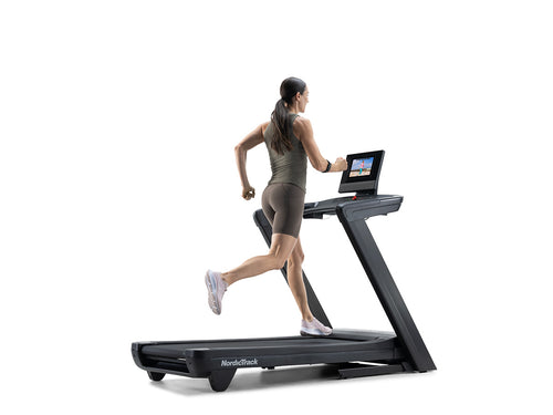 Nordic Track Commercial 1250 Treadmill with woman running on it against a white background.