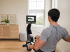 Nordic Track RW700 Rower. Man rowing and looking at the console whilst in a programme.