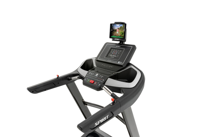 Spirit XT485 Treadmill showing angled view of tablet holder with tablet and downloaded app, black LCD screen, incline and speed buttons, hand grip pulse, fan and incline and speed toggles on handlebars.