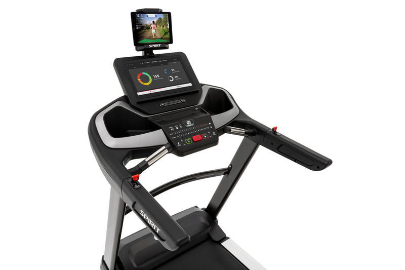 Spirit XT685 ENT flat bed treadmill with Touch Screen showing angled view of tablet holder with table and downloaded app, side handle bars with toggles and speed and incline buttons.