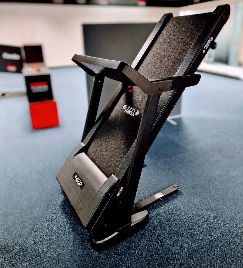 York Barbell HT9 Folding Treadmill folded in room