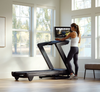 Nordic Track Commercial 2450 Treadmill with female rotating the console.