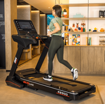 Female model running on the BH  RS900 LED Treadmill in a room setting. Available at Fitness Options. www.fitnessoptions.co.uk