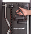 Hand holding accessory stirrup handle attached to the accessory rack at the rear of the machine