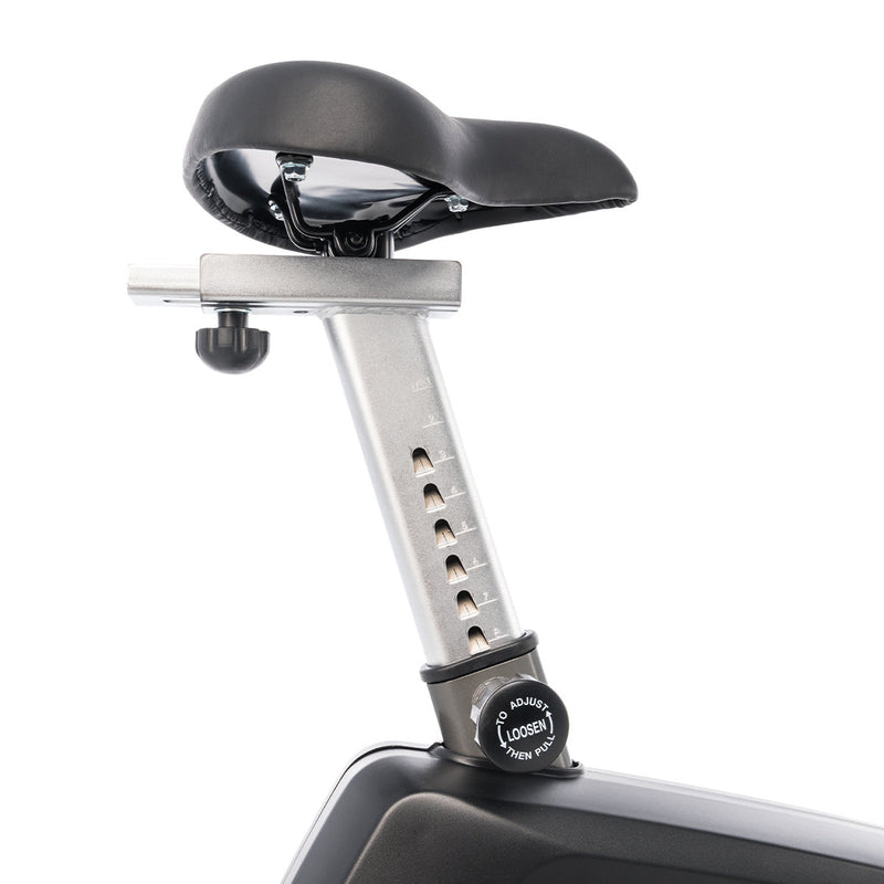 A close up of the horizontal and vertical adjustment of the saddle of the Spirit CU800+ Upright bike in Graphite Grey built for commercial establishments
