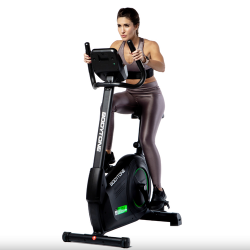 Woman exercising on a Bodytone EVOU4 light commercial upright exercise bike against a white background